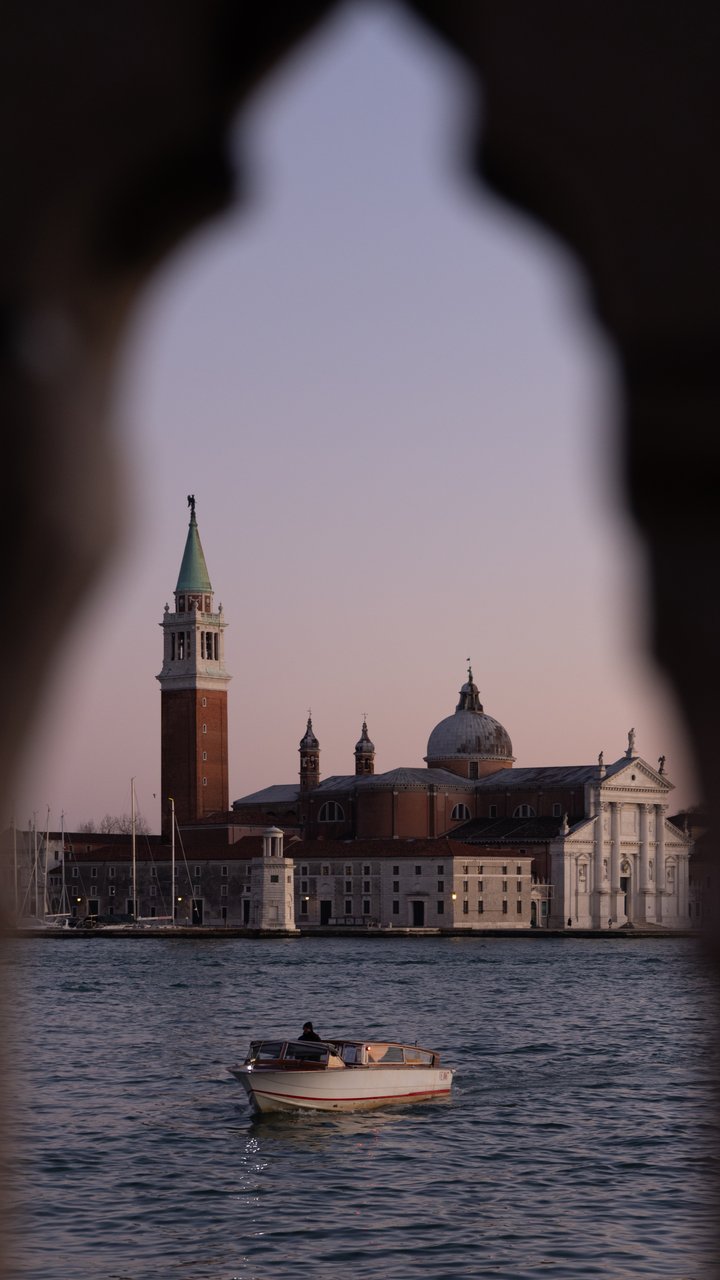 The unedited photo: A Venetian church across the lagoon, seen through a stone arch